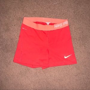 Orange/coral Nike pro shorts
